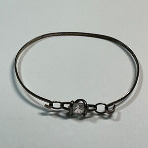 Sterling Silver Mexican open hinged braclet with a clear faceted stone.